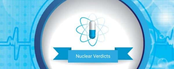 A pill with four electron paths surrounding it to symbolize an atom 